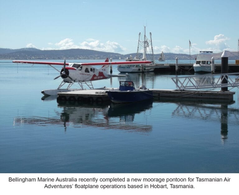 Floatplane moorage system Hobart with a floatplane docked on calm water, surrounded by lush greenery and a clear sky.