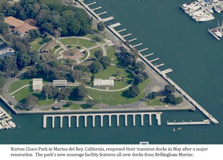 Aerial view of Burton Chace Park transient docks with boats moored along floating docks surrounded by water.