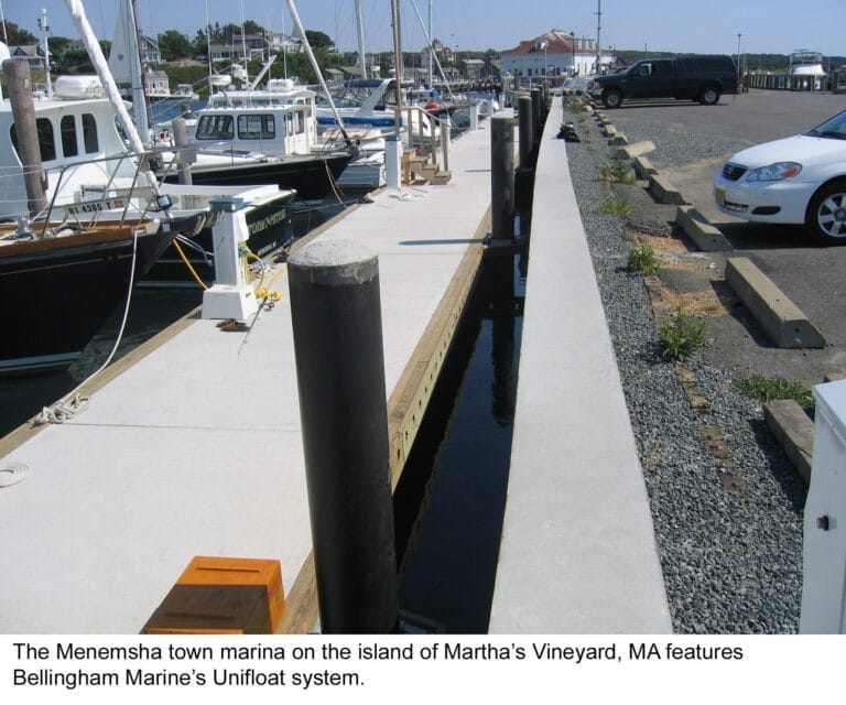 Unifloat dock system Menemsha with boats moored at a marina, featuring calm water and a clear sky in the background.