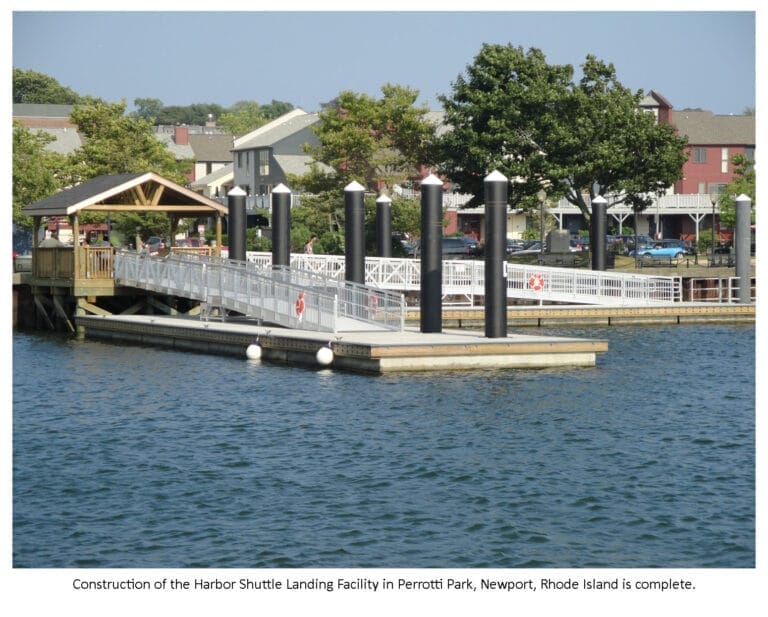 Newport Harbor Shuttle Landing Facility at Perrotti Park with boats docked and a view of the waterfront on a clear day.