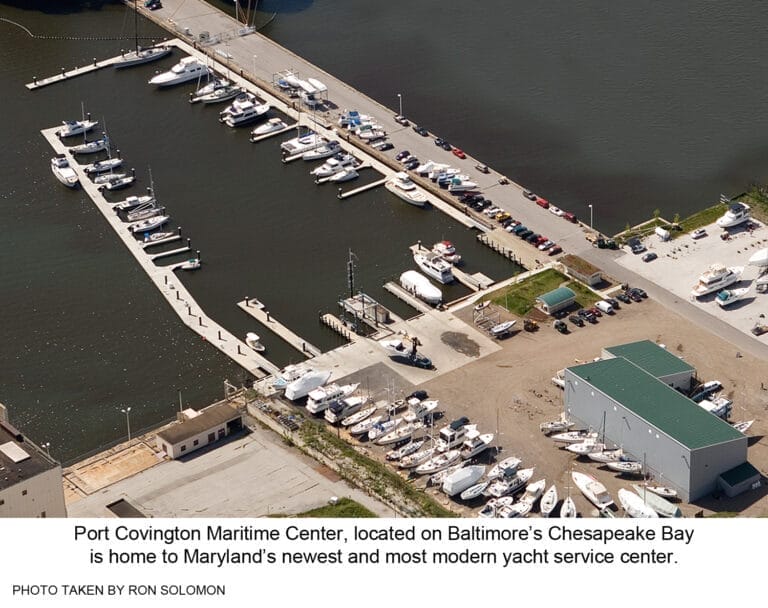 A modern yacht docked at an eco-friendly yacht service center on Chesapeake Bay, with green facilities in the background.
