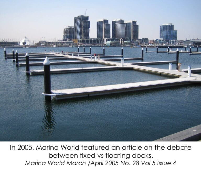 A serene marina scene showcasing floating vs fixed concrete docks, with boats moored alongside both types under a clear sky.