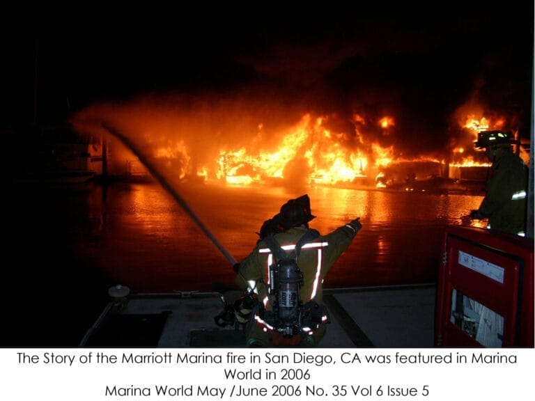 Firefighters in action at night, tackling a blaze at a marina, highlighting marina fire response challenges with smoke and fl