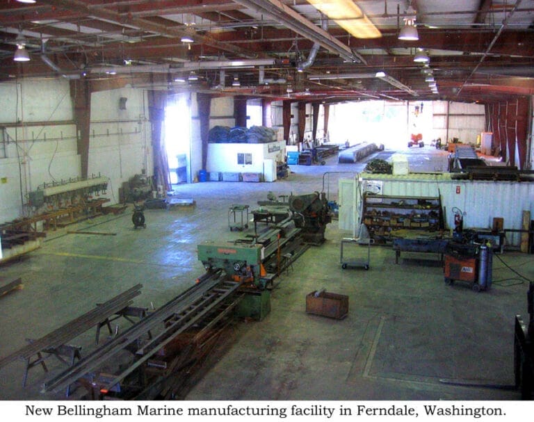 Construction site with cranes and scaffolding at Bellingham Marine facility expansion, showcasing progress and development.
