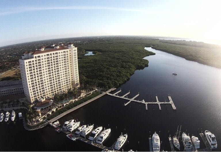 Tarpon boat docked at a concrete floating dock system in a marina, showcasing the stability and design of the dock.