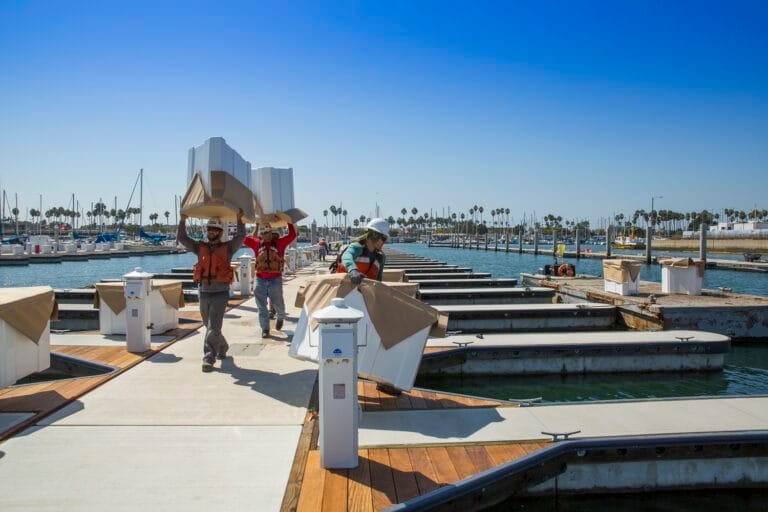 Aerial view of a marina under construction, showcasing docks and boats. Maximize marina investment tips for successful planni