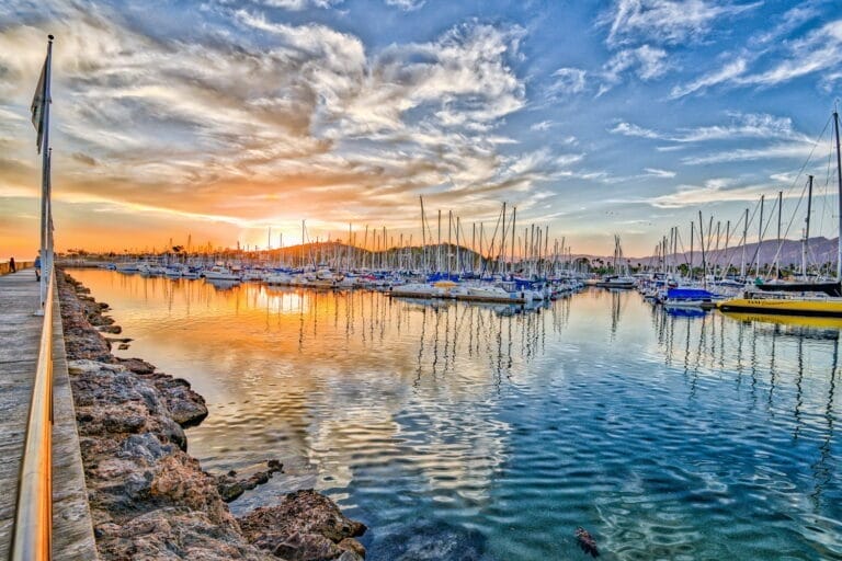 rebuild marina on a budget - Sunset view of Santa Barbara Harbor's Marina 1, showcasing a rebuilt marina on a budget with boa