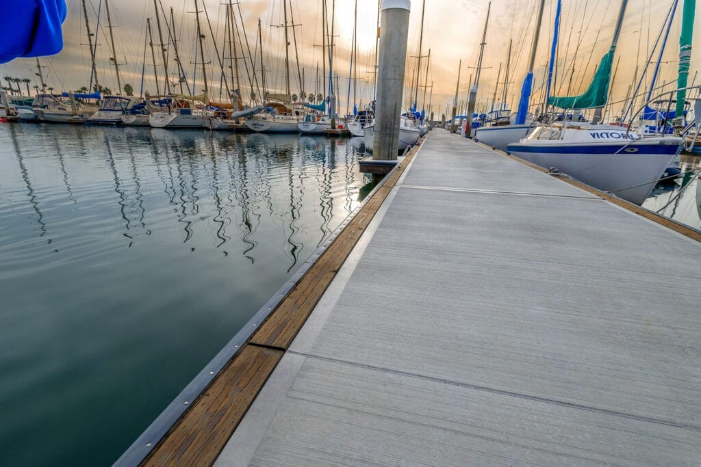 A modular concrete dock system with multiple floating sections on a calm body of water, showcasing durability and stability.