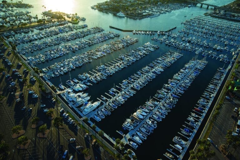 Aerial view of Alamitos Bay Marina project showcasing docks and boats in a calm bay with surrounding urban landscape.
