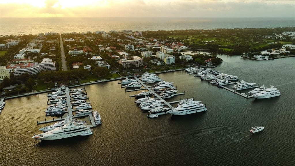 Aerial view of the Palm Beach Marina Project showing docks and boats against a backdrop of the town and waterfront.