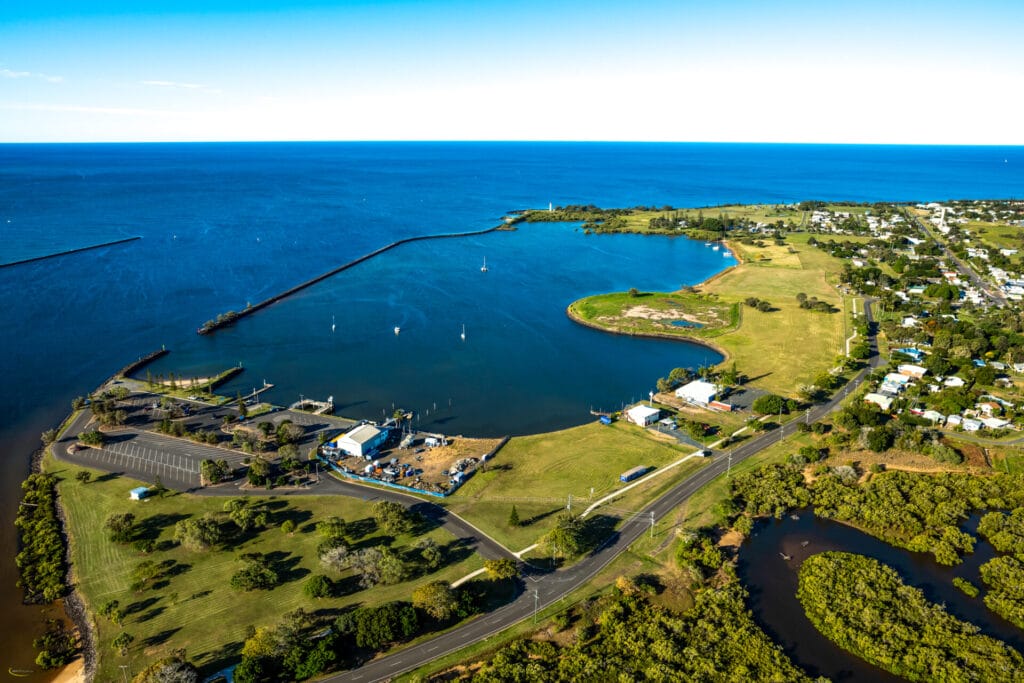 Aerial view of the Gateway Marina development Burnett Heads showcasing docks, boats, and surrounding landscape.